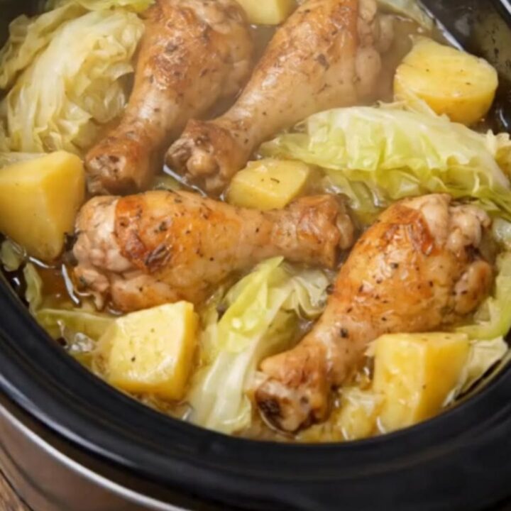 Slow cooker chicken drumsticks served over a bed of tender cabbage wedges and baby yellow potatoes.