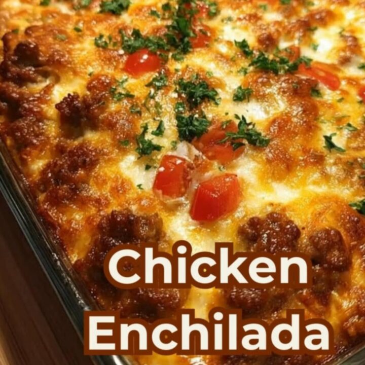 A spatula lifting a steaming, gooey portion of chicken enchilada casserole with an epic cheese pull