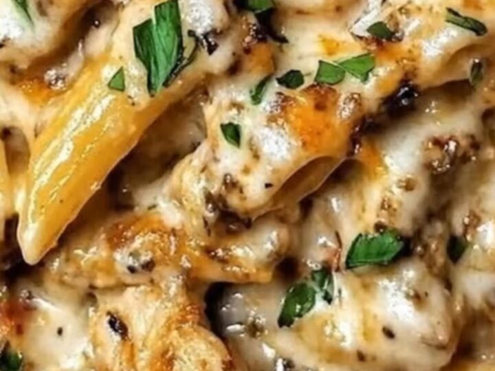 A close-up of baked garlic butter chicken penne in a skillet, topped with golden