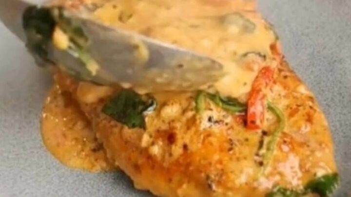 A close-up of tender sliced chicken breasts smothered in a rich