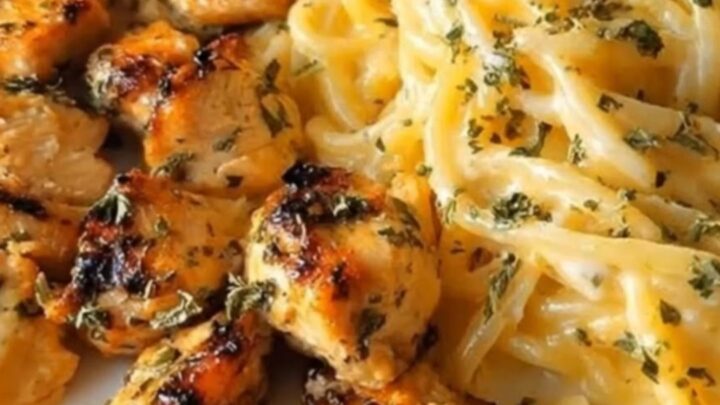A plate of garlic butter chicken spaghetti coated in a rich, creamy cheddar parmesan sauce.