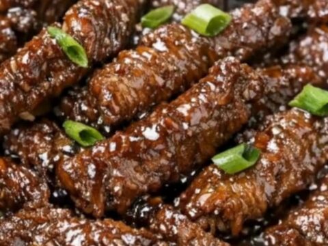 A close-up shot of slow cooker Mongolian beef strips coated in a thick