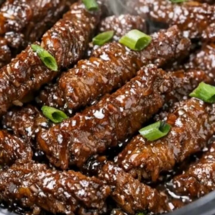 A close-up shot of slow cooker Mongolian beef strips coated in a thick