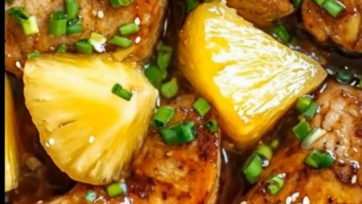 Tender slow cooker pineapple teriyaki pork chops topped with fresh green onions and sesame seeds