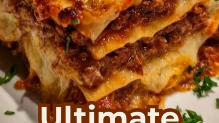 A thick-layered slice of classic cheesy beef lasagna on a white plate
