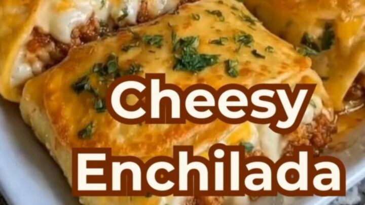 A spatula lifting a cheesy beef enchilada stack from a white casserole dish with a dramatic cheese pull.