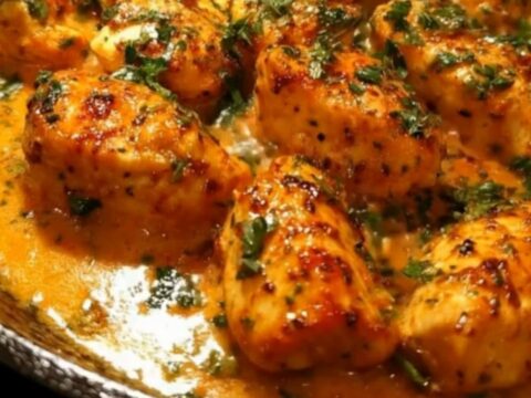 Golden-seared chicken bites simmered in a rich, bubbling garlic butter cream sauce in a cast-iron skillet