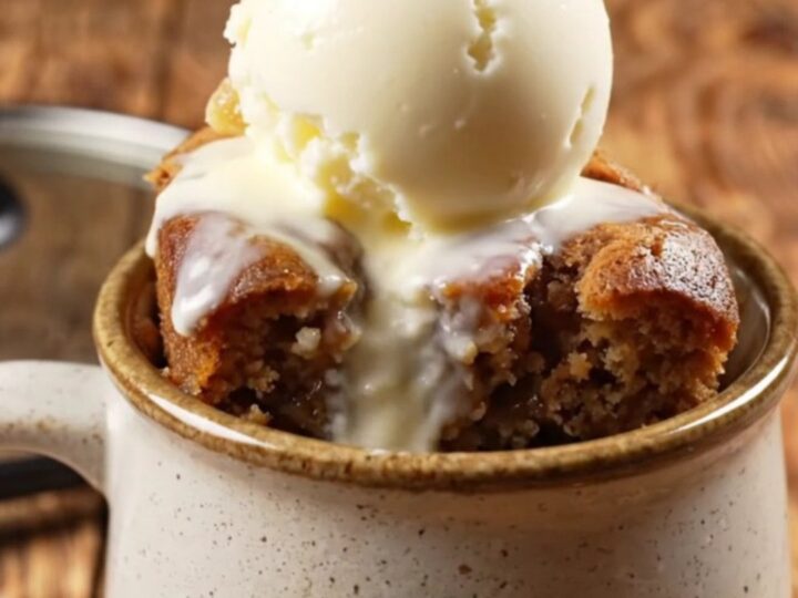 A warm, rustic Crockpot filled with spiced gingerbread pear dump cake topped with butterscotch.