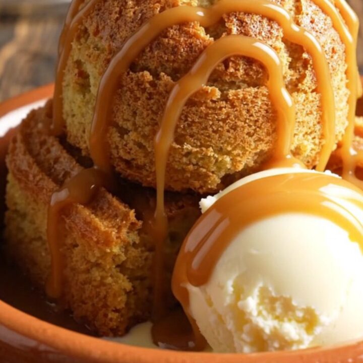 A warm, bubbling Crockpot churro cake with molten dulce de leche and a golden cinnamon crust.