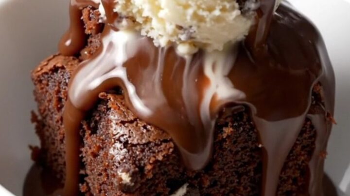 A close-up of a slow cooker filled with a rich, bubbling Oreo chocolate fudge cake.