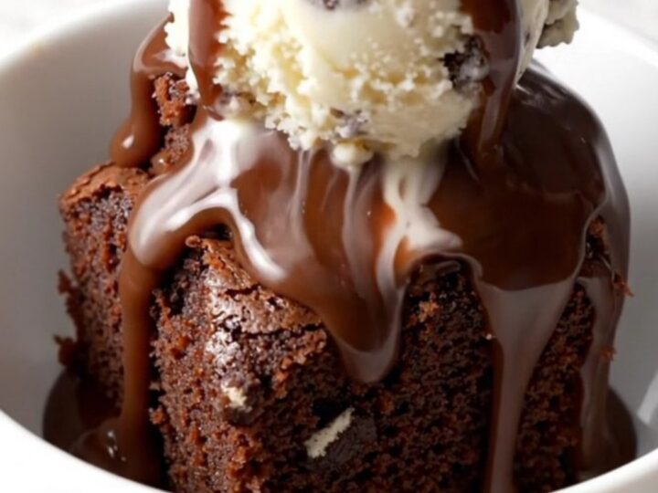 A close-up of a slow cooker filled with a rich, bubbling Oreo chocolate fudge cake.