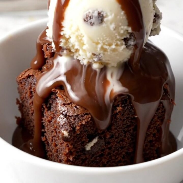 A close-up of a slow cooker filled with a rich, bubbling Oreo chocolate fudge cake.