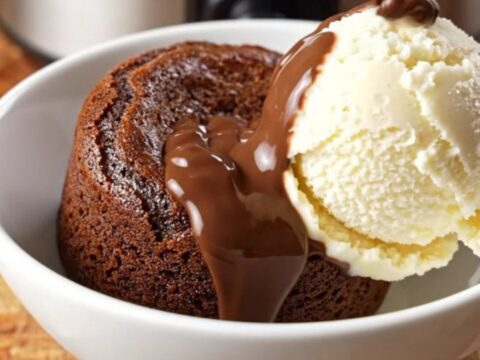 A close-up of a molten Nutella lava cake in a glossy brown slow cooker