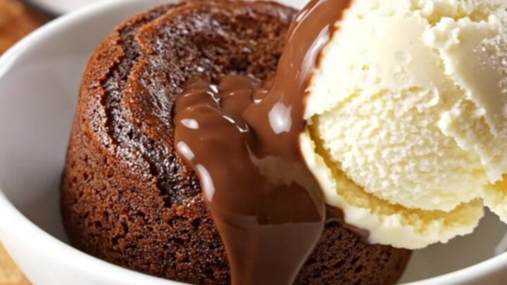 A close-up of a molten Nutella lava cake in a glossy brown slow cooker