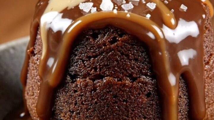 A steaming scoop of chocolate mocha lava cake in a stoneware bowl topped with coffee ice cream and sea salt.