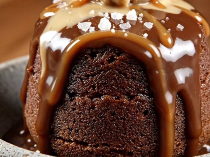 A steaming scoop of chocolate mocha lava cake in a stoneware bowl topped with coffee ice cream and sea salt.