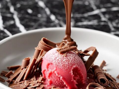 A decadent triple chocolate crockpot volcano cake with a molten ganache center served in a dark bowl.