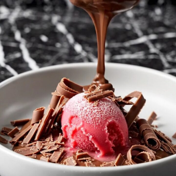 A decadent triple chocolate crockpot volcano cake with a molten ganache center served in a dark bowl.