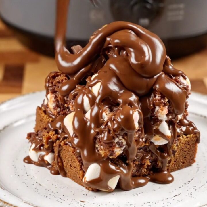 Close-up of gooey s'mores monkey bread being pulled apart with melted marshmallow strings.