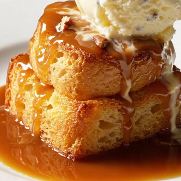 A warm, golden-brown Bananas Foster bread pudding in a slow cooker with steam rising.