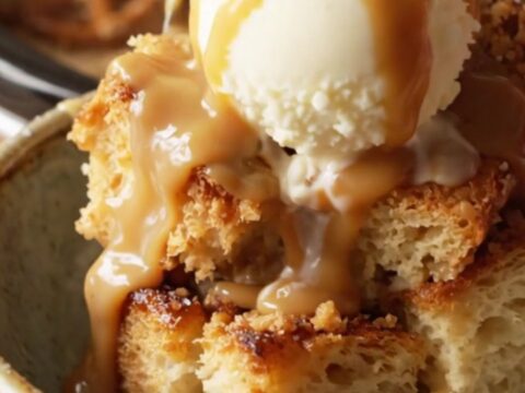 A close-up view of the slow-cooker bread pudding with caramel sauce and pretzels.