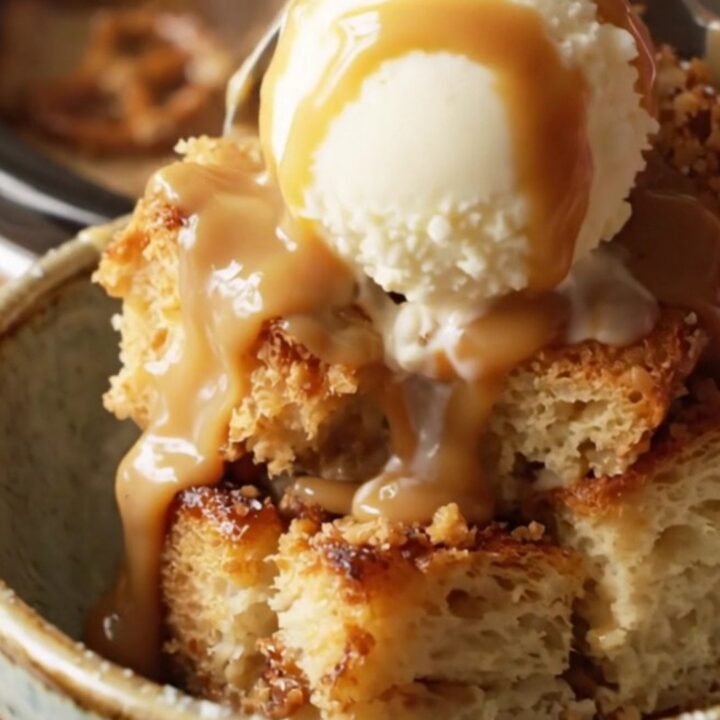 A close-up view of the slow-cooker bread pudding with caramel sauce and pretzels.