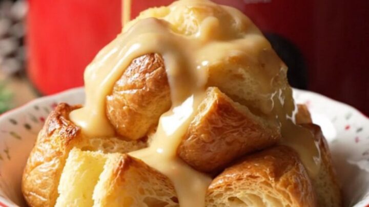 A festive bowl of golden eggnog rum bread pudding drizzled with creamy glaze and dusted with fresh nutmeg.