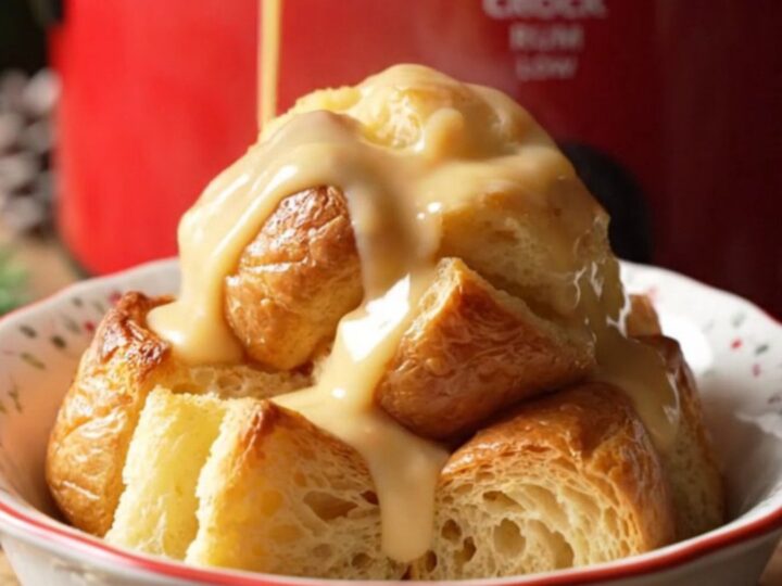 A festive bowl of golden eggnog rum bread pudding drizzled with creamy glaze and dusted with fresh nutmeg.