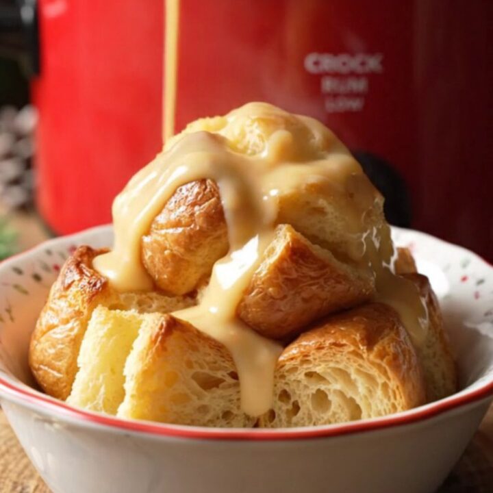 A festive bowl of golden eggnog rum bread pudding drizzled with creamy glaze and dusted with fresh nutmeg.