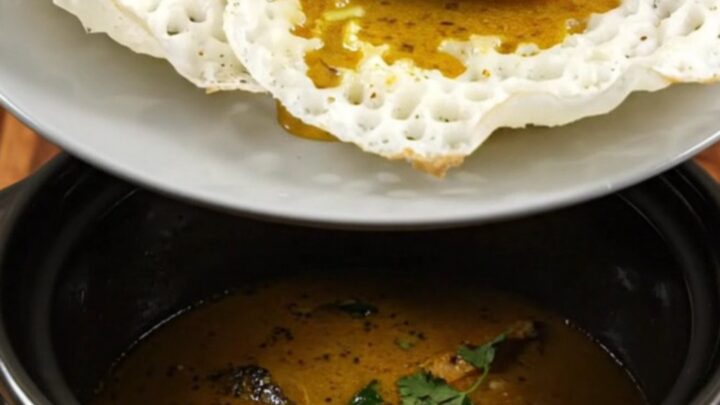 A close-up of Kerala Fish Molee with golden coconut sauce and kingfish in a Crockpot.