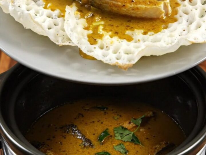 A close-up of Kerala Fish Molee with golden coconut sauce and kingfish in a Crockpot.