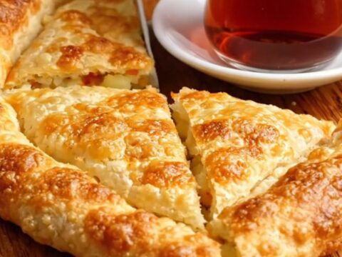 Golden blistered Turkish gözleme cut into triangles, showing creamy potato and melted cheese filling