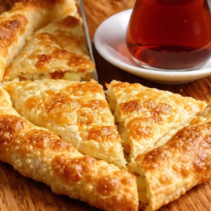 Golden blistered Turkish gözleme cut into triangles, showing creamy potato and melted cheese filling
