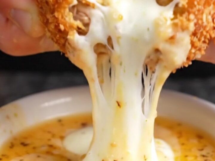 Golden brown crispy chicken potato croquettes stacked on a plate with a creamy dip