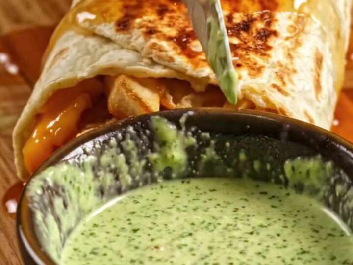 Honey butter chicken strip burrito cut in half, showing crinkle fries, melted Monterey Jack, and jalapeño ranch
