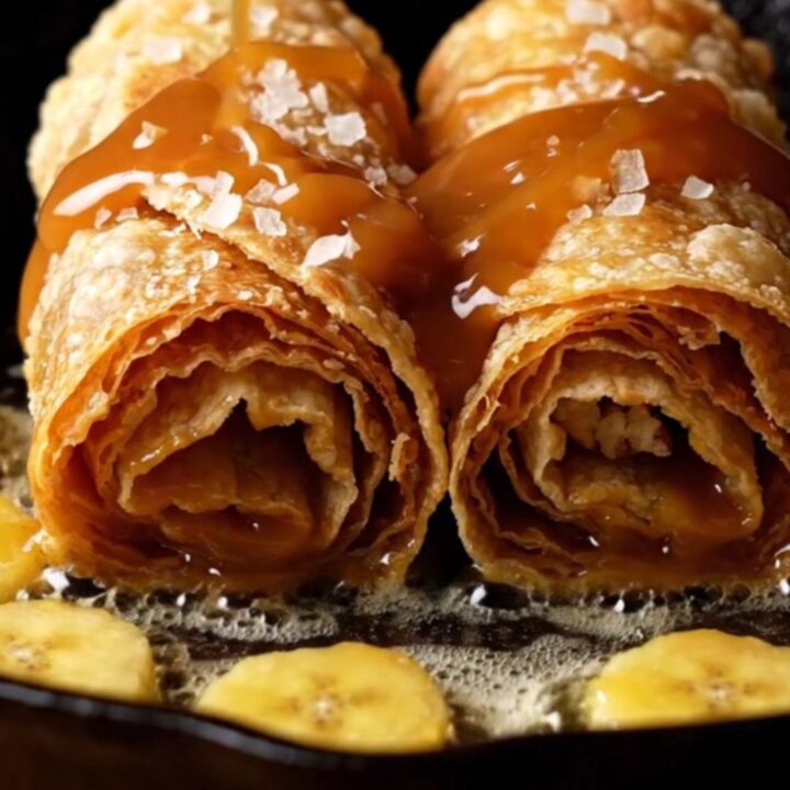 Crispy fried banana Foster roll-up halves oozing dulce de leche, caramelized bananas and pecans, drizzled with rum caramel