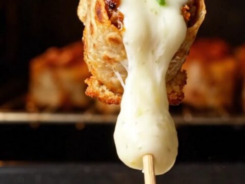 Glazed beef tortilla kebabs on a skewer with melted cheese and honey paprika glaze
