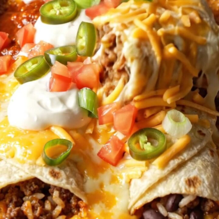A baked enchilada-style beef burrito lifted from a bubbling 9x13 dish