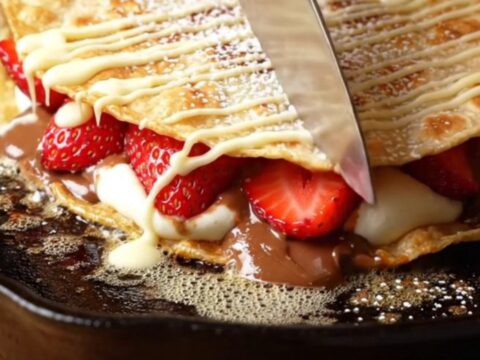 Crispy golden dessert quesadilla wedges with molten hazelnut-chocolate filling, fresh strawberries