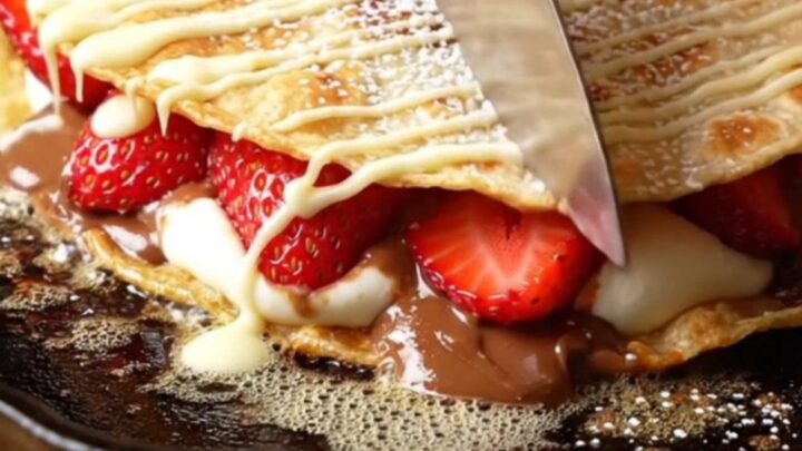 Crispy golden dessert quesadilla wedges with molten hazelnut-chocolate filling, fresh strawberries