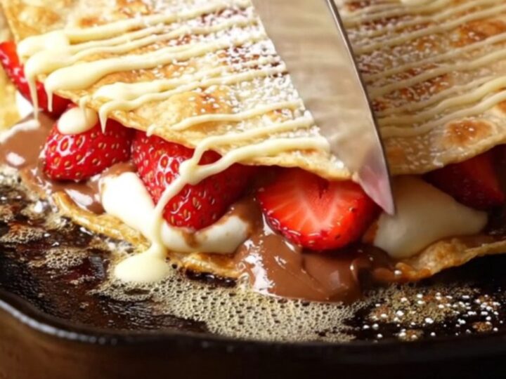 Crispy golden dessert quesadilla wedges with molten hazelnut-chocolate filling, fresh strawberries