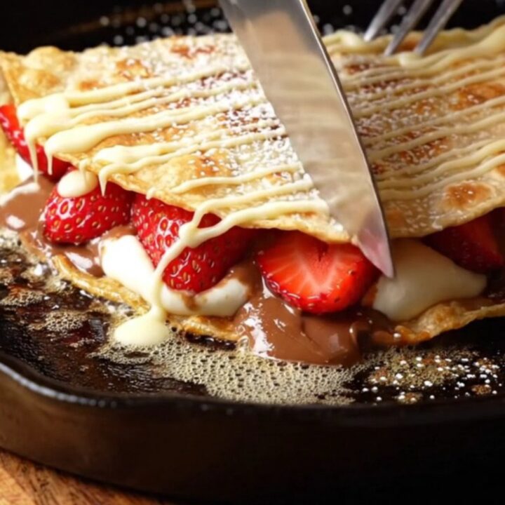 Crispy golden dessert quesadilla wedges with molten hazelnut-chocolate filling, fresh strawberries