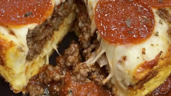 A thick slice of impossible pizza pie lifted from a black pan with a long cheese pull, steam rising