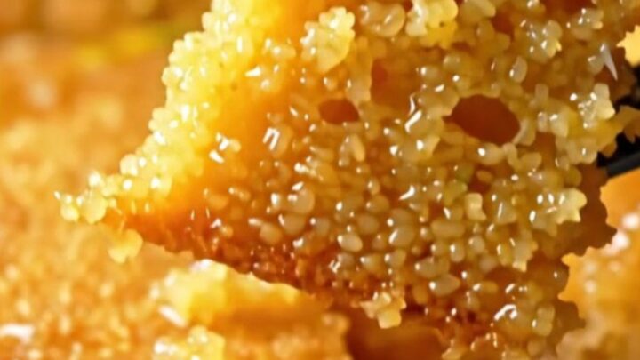 Golden Revani semolina cake with lemon syrup, topped with crushed pistachios and coconut