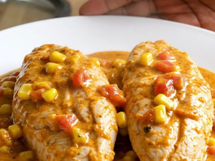 Shredded crockpot cream cheese taco chicken in a thick creamy taco sauce with corn and diced tomatoes