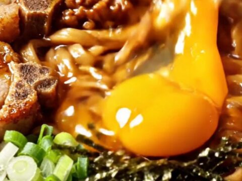 Taiwan mazesoba dry noodles topped with five-spice pork chop slices, spicy minced pork, nori, and a glossy golden egg yolk