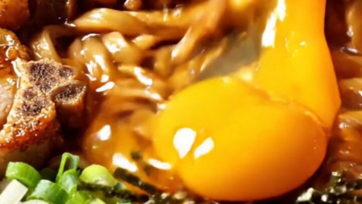 Taiwan mazesoba dry noodles topped with five-spice pork chop slices, spicy minced pork, nori, and a glossy golden egg yolk