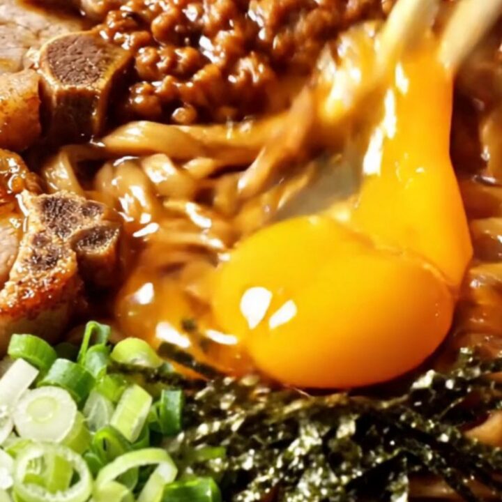 Taiwan mazesoba dry noodles topped with five-spice pork chop slices, spicy minced pork, nori, and a glossy golden egg yolk