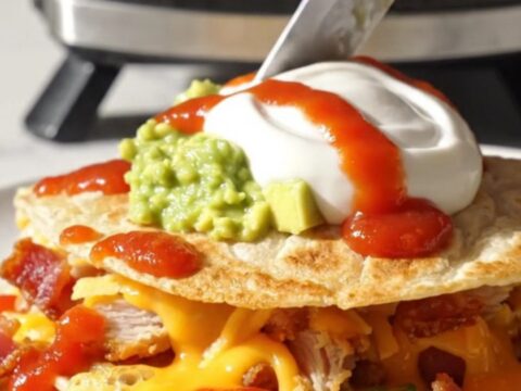 Golden waffle-iron quesadilla triangle with deep crispy pockets of melted cheddar and bacon