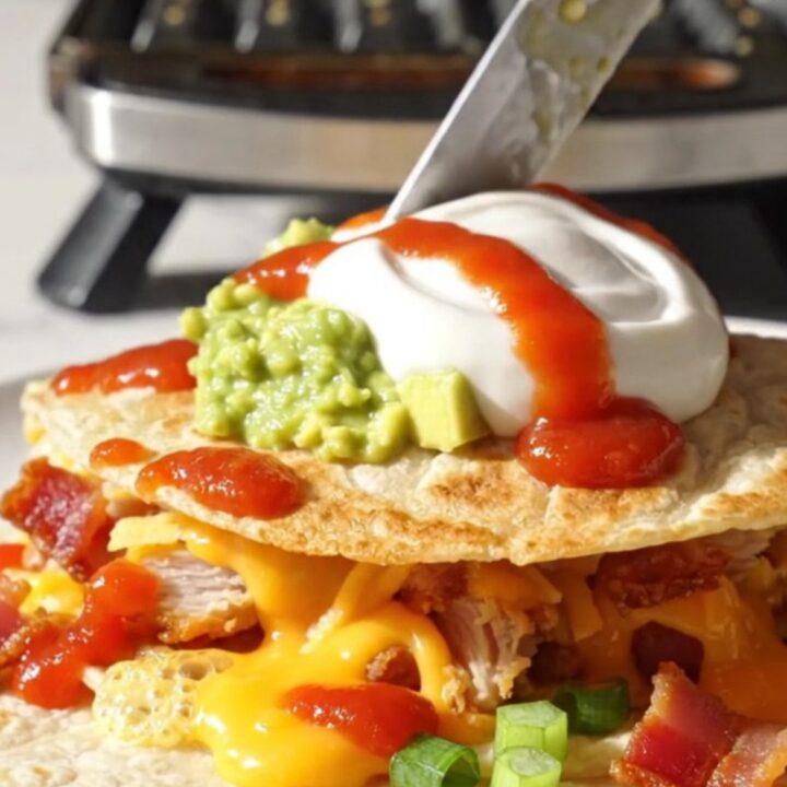 Golden waffle-iron quesadilla triangle with deep crispy pockets of melted cheddar and bacon